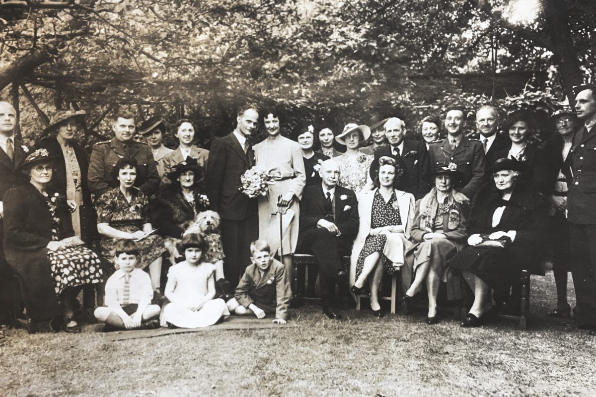 A black and white photo of a group at a wedding