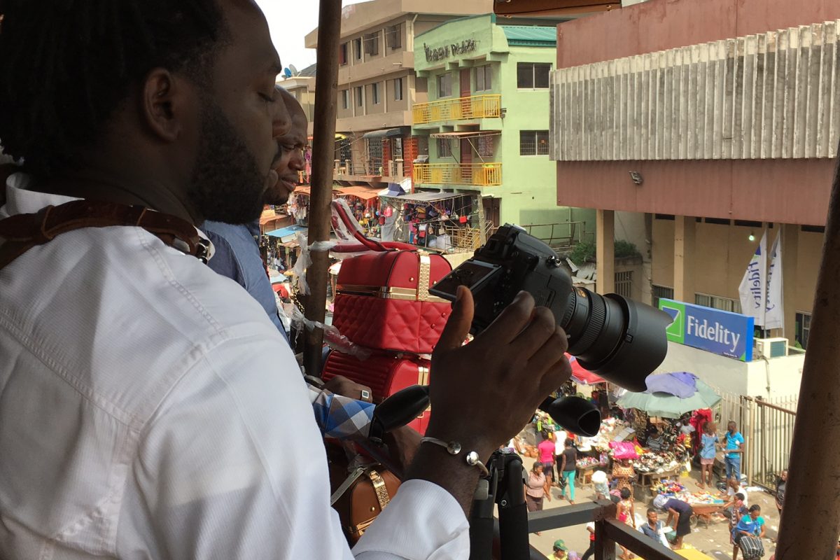 Man looking out to market square with camera in hand.