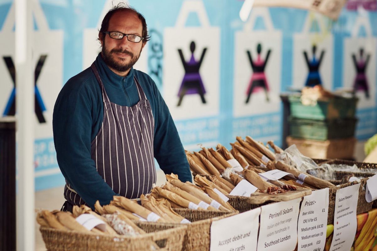 A man behind a salami counter