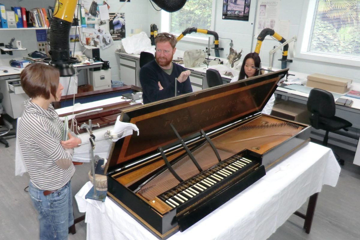 conservators around the Chickering clavichord