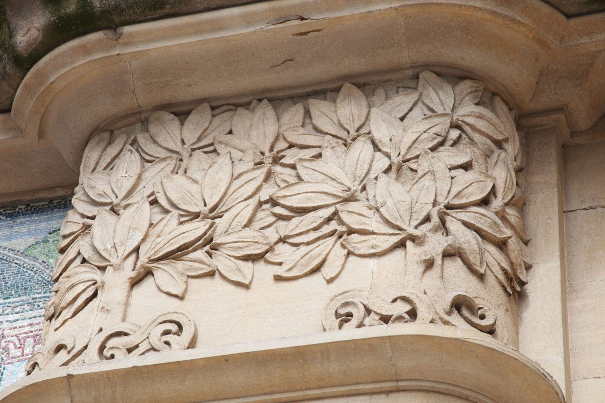 A close up of some trees carved onto the stone facade of the Horniman building