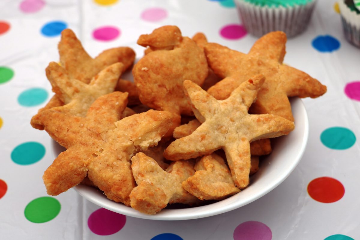 starfish shaped biscuits in a white bowl on table.