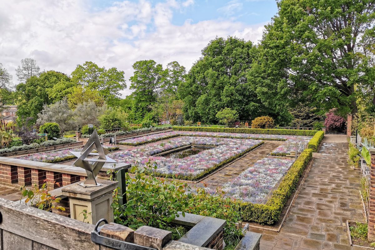 Large square garden with small pond in the centre