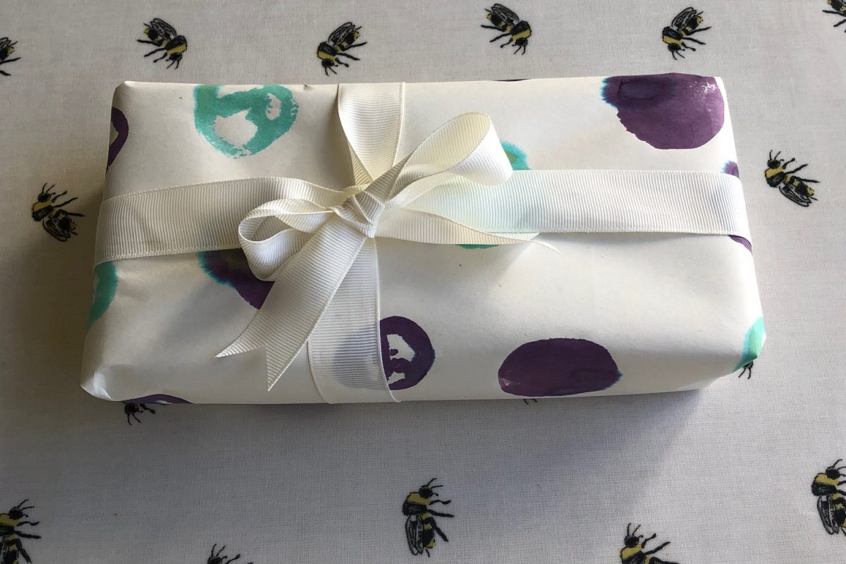 Present wrapped with spotted paper and white ribbon