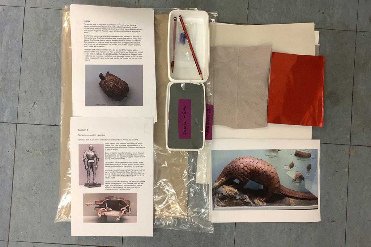 An art pack containing worksheets, pencils, pictures, and tissue paper