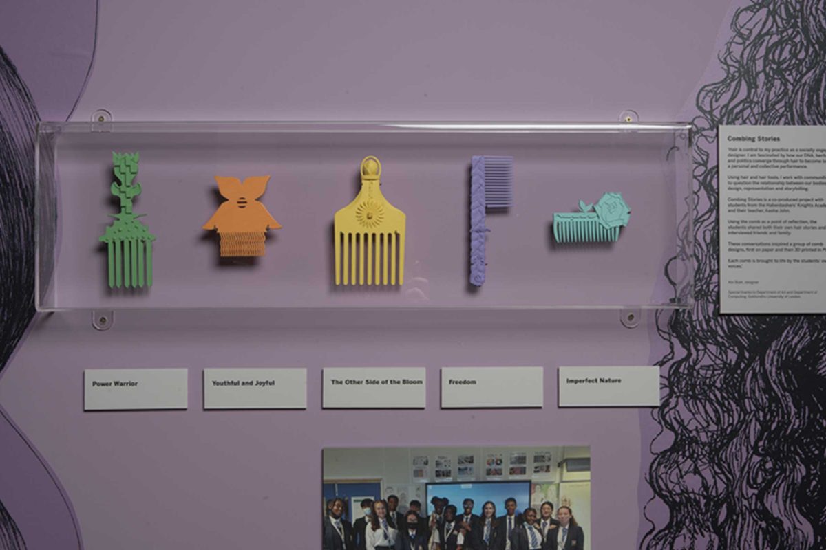 Five colourful combs in different shapes and sizes mounted on a wall