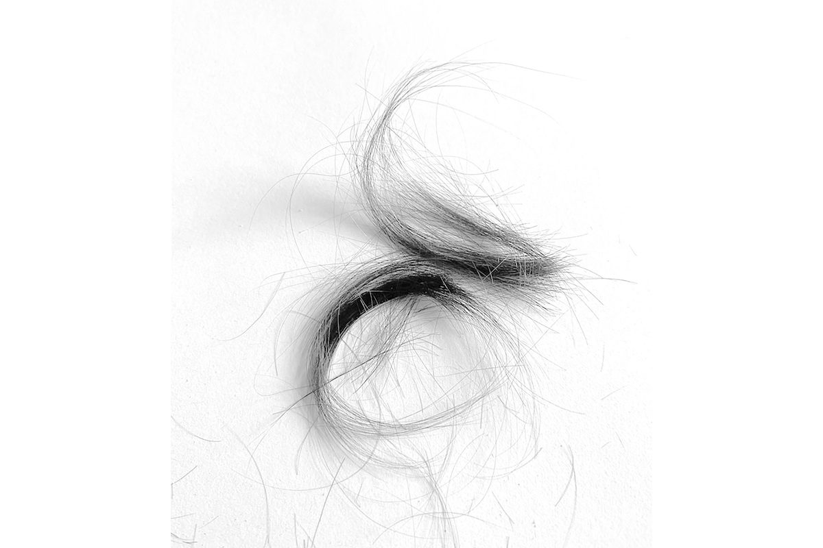 Black and white close up photo of cut hair