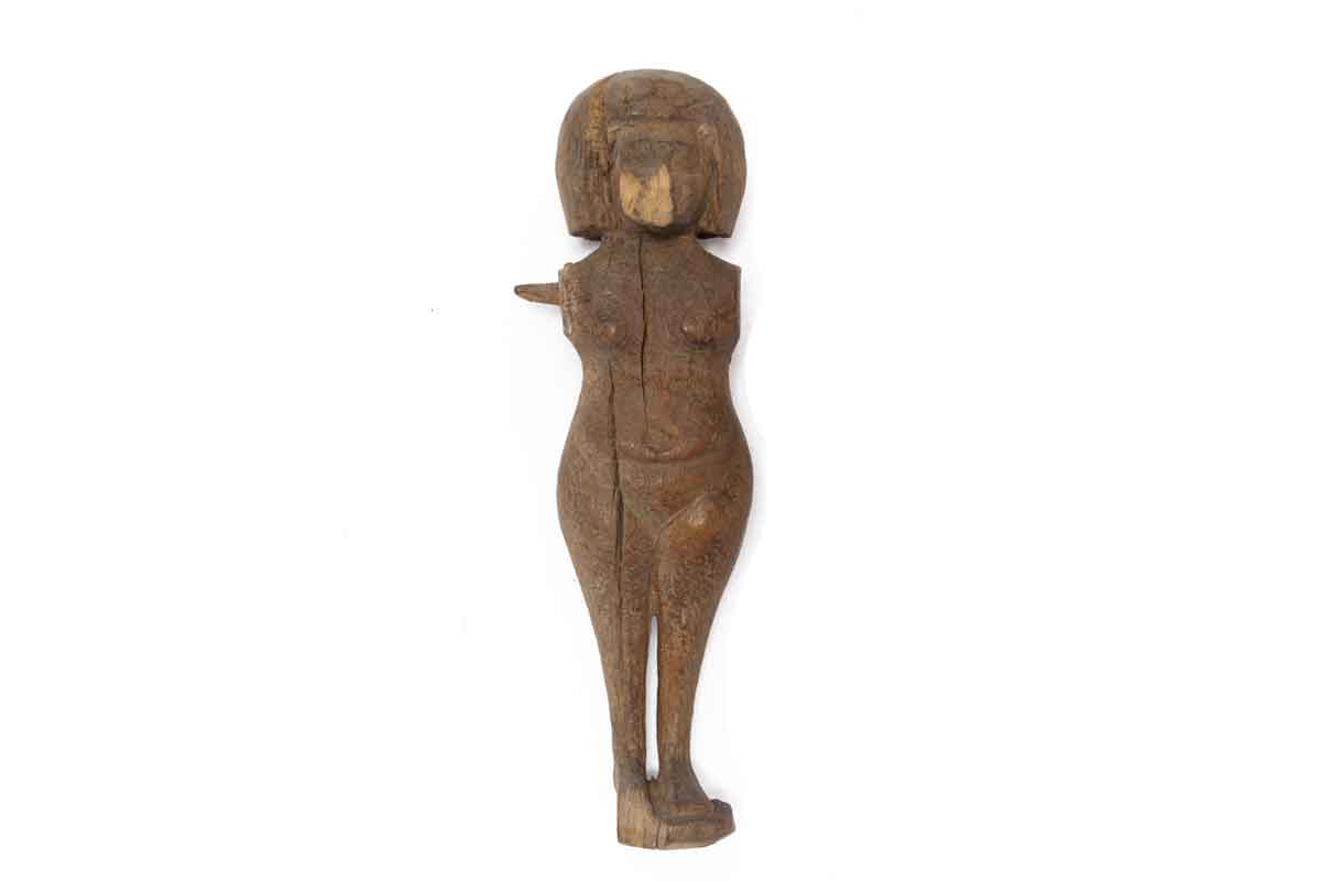 Carved, wooden doll representing a nude adolescent or adult woman on a small plinth