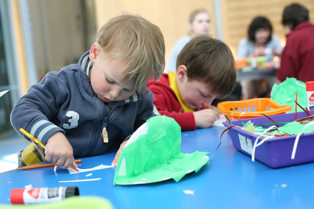 Two children join a craft activity at the Horniman