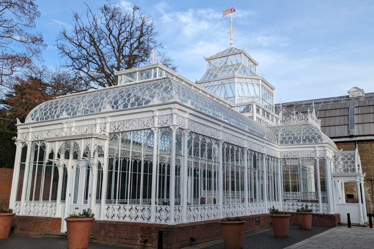 The Horniman Conservatory as seen from the side on a day with blue sky