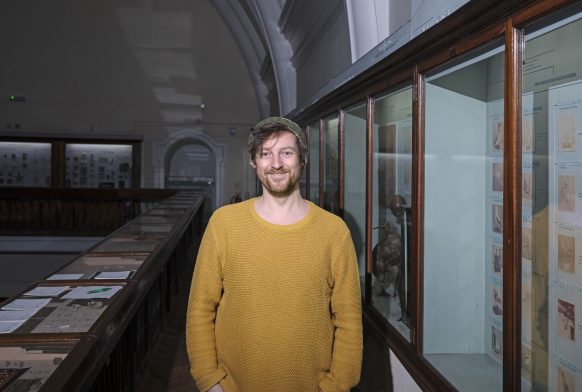 Chris Hughes stands on the Natural History balcony